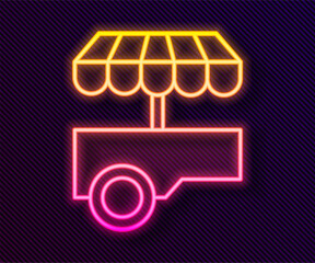 Wall Mural - Glowing neon line Fast street food cart with awning icon isolated on black background. Urban kiosk. Vector