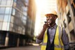 African American male engineer or contractor with smile talking on smartphone in architecture. Black man, architect and phone for construction in the city or building, conversation and discussion.