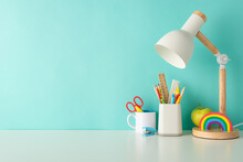 Cultivate Efficient Learning Habits With This Side-view Photo Featuring White Desk With Colorful Office Supplies, Organizer, And Lamp On A Blue Backdrop, Accompanied By Ample Space For Text Or Advert