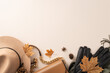 Embrace the spirit of autumn with stylish and warm clothing: handbag, felt hat, gloves and scarf on top view photograph against a white isolated background, providing space for text or advertising