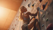 Sportswoman starting a climbing wall , young adult woman doing sports
