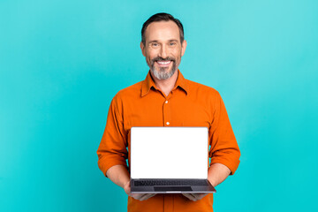 photo of intelligent cheerful smart man wear stylish shirt hold laptop presenting empty space monito