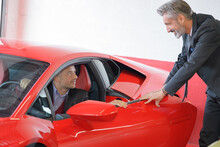 Sports Car Dealer And His Customer