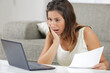 © auremar - worried woman reading negative news in letter