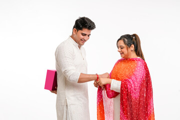 Indian good looking young brother and sister celebrating Raksha Bandhan or Rakhi festival.