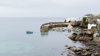 Wall Mural - Traditional Cornish fishing boat at Coverack harbour with the tide out