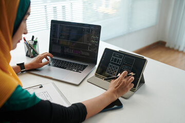 Wall Mural - Front end developer checking wireframe on table screen when coding