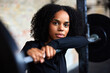 © Flamingo Images - Focused woman leaning on weights in a gym