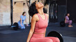 © Flamingo Images - Young woman resting during a gym workout