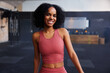 © Flamingo Images - Smiling young woman standing in a gym