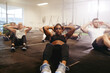 © Flamingo Images - Fit woman working her core during an exercise class