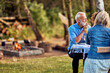 © Flamingo Images - Man talking with family at a table outdoors