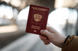 © Viktoriia - Russian passport on a black travel suitcase, selective focus. Emigration of Russians from the country, problems with visas, refugees