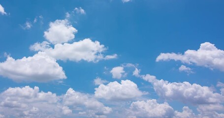 Wall Mural - Cloud blue sky background Time lapse Beautiful white clouds approach the point of view backed by a vivid blue sky in this one minute loop Time lapse raw photo interval at 1 second fade at video's end