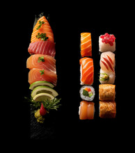 Set Of Different Types Of Sushi. Stack Of Sushi In Black Background. Sushi With Salmon.