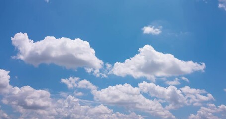 Wall Mural - Cloud blue sky background Time lapse Beautiful white clouds approach the point of view backed by a vivid blue sky in this one minute loop Time lapse raw photo interval at 1 second fade at video's end