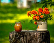 © Валентина Хруслова - Bees flocked to a jar of honey standing on an old stump in the garden in the apiary