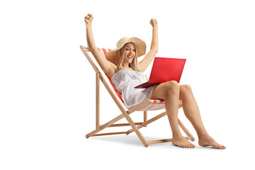 Poster - Happy young woman in a white dress sitting on the beach chair with a laptop computer