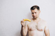 A man holds a banana in his hand. Potency problems. guys health