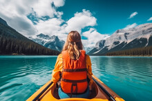 Beautiful Woman On A Kayak On A Big Lake With Big Mountains In Background. Back View Of Woman On Kayak.