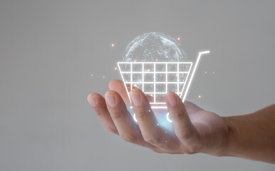 Online shopping concept. customer hand holding the shopping cart icon on the virtual screen for global concepts.