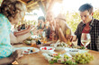 © Geber86 - Multigenerational family enjoying a family lunch on a patio at a vineyard