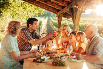 Wall Mural - Multigenerational family having a family lunch outdoors on a patio