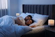 © New Africa - Lovely couple sleeping together in bed at night