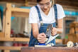© EKKAPON - Carpenter working with strong female hands