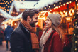 © MVProductions - A young cheerful couple having a walk with hot drinks, dressed warm, looking at each other and laughing, snowflakes all around. Enjoying Christmas Market
