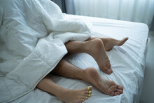 Close Up Feet Of Young Couple Starting Foreplay And Making Love On Bed. 