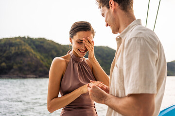 Caucasian young man make surprise proposal of marriage to girlfriend. 