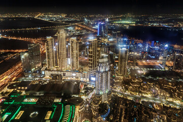 Night view from the observation deck of the tallest building in the world - Burj Khalifa illuminated by lights the Dubai city, United Arab Emirates