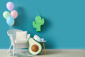 Interior of living room decorated for birthday with balloons and pinatas