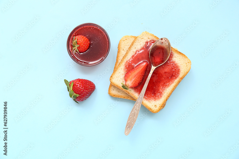 Tasty toasts with sweet strawberry jam on blue background