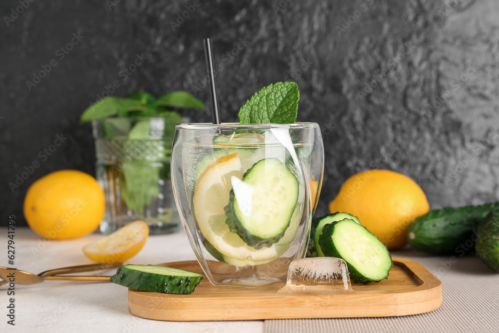 Glasses of lemonade with cucumber and mint on white table