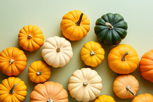 Small Orange, White And Green Pumpkins On Pastel Background