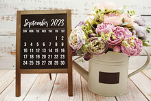 September 2023 Monthly Calendar With Green Leaf Decoration On Wooden Background