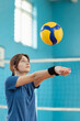 Girl on court, training digging, passing skills before volleyball game. Professional female volleyball player, sports concept