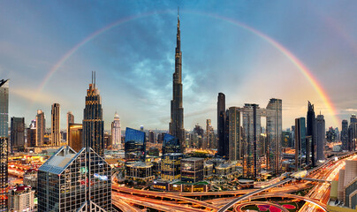 Wall Mural - Rainbow over Skyline of Dubai bussines downtown at sunrise, United Arab Emirates