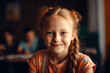 Portrait of cute redhead pupil girl at the desk in classroom. Back to school concept
