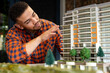 © Wavebreak Media - Biracial male architect working on a building model at office