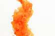 Close up of orange ink in water with copy space on white background