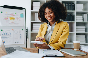 Young asian female work with financial papers at home count on calculator before paying taxes receipts online, planning budget glad to find chance for economy saving money, audit concepts.