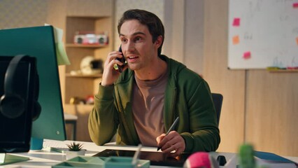 Wall Mural - Happy artist answering cellphone call drawing tablet close up. Man talking phone
