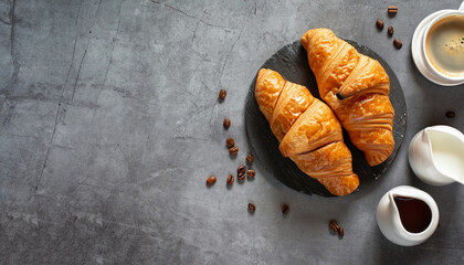 Coffee and croissant on stone table. French breakfast. Top view flat lay with copy space for your text