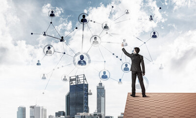 Wall Mural - businessman on house roof presenting networking and connection c