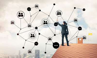Wall Mural - businessman on house roof presenting networking and connection c