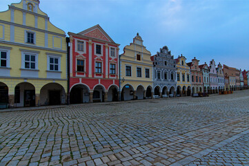 Wall Mural - Wide-angle landscape view of colorful facade of historical buildings on the market square in Telc, the Czech Republic. Cloudy summer morning. UNESCO World Heritage Site