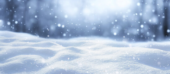 Winter snow background with snowdrifts, with beautiful light and snow flakes on the blue sky in the evening, banner format, copy space.